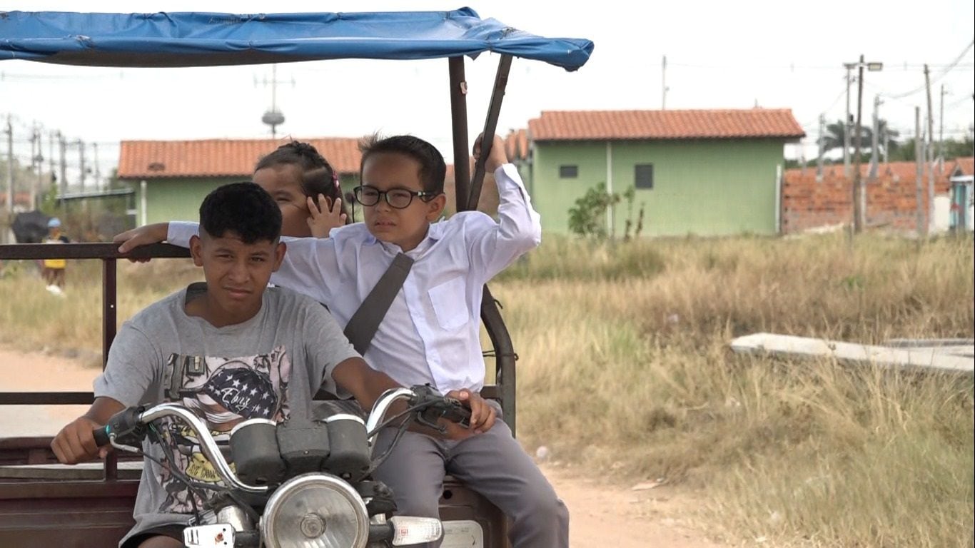 Niños van en motocarro en búsqueda de cumplir el anhelo de estudiar, pero lejos de su comunidad en el complejo San Blas de Mariano Roque Alonso.