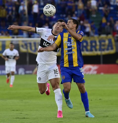 Guillermo Paiva disputa el balón con José Leguizamón, en el duelo entre Olimpia y Luqueño.