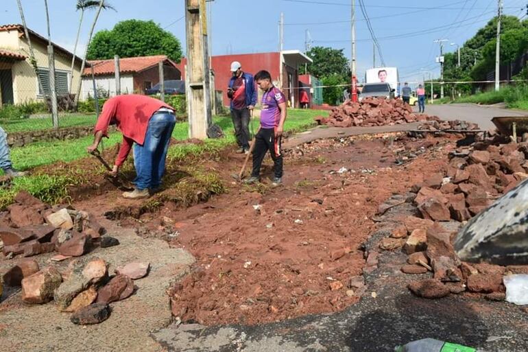 Obreros de la municipalidad de Villa Elisa proceden a reparar las vías destrozadas por los raudales.