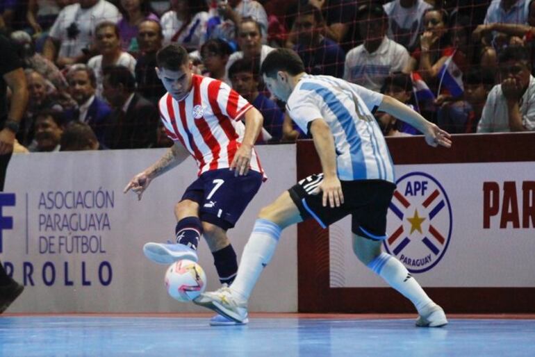 Javier Salas intenta el pase ante la oposición del defensa argentino. Paraguay ganó un amistoso y Argentina el otro.