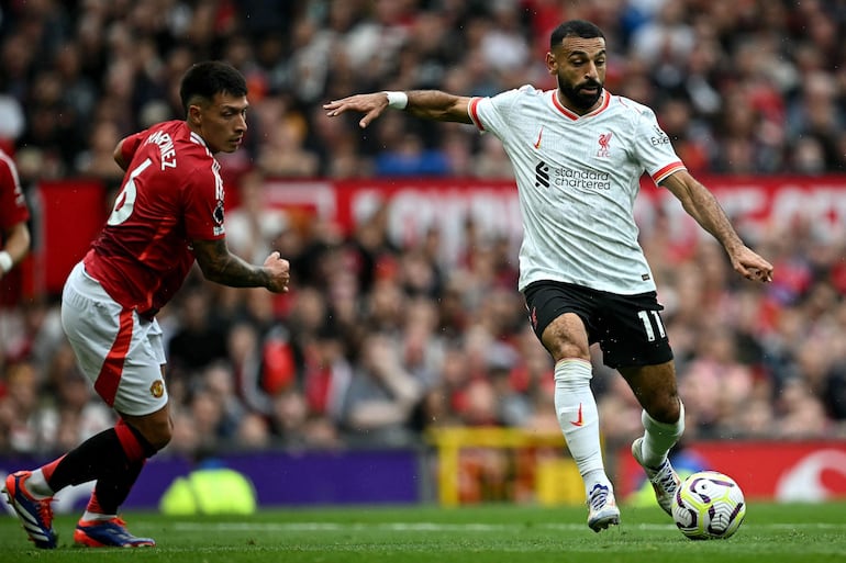 Liverpool's Egyptian striker #11 Mohamed Salah crosses the ball during the English Premier League football match between Manchester United and Liverpool at Old Trafford in Manchester, north west England, on September 1, 2024. (Photo by Paul ELLIS / AFP) / RESTRICTED TO EDITORIAL USE. No use with unauthorized audio, video, data, fixture lists, club/league logos or 'live' services. Online in-match use limited to 120 images. An additional 40 images may be used in extra time. No video emulation. Social media in-match use limited to 120 images. An additional 40 images may be used in extra time. No use in betting publications, games or single club/league/player publications. / 