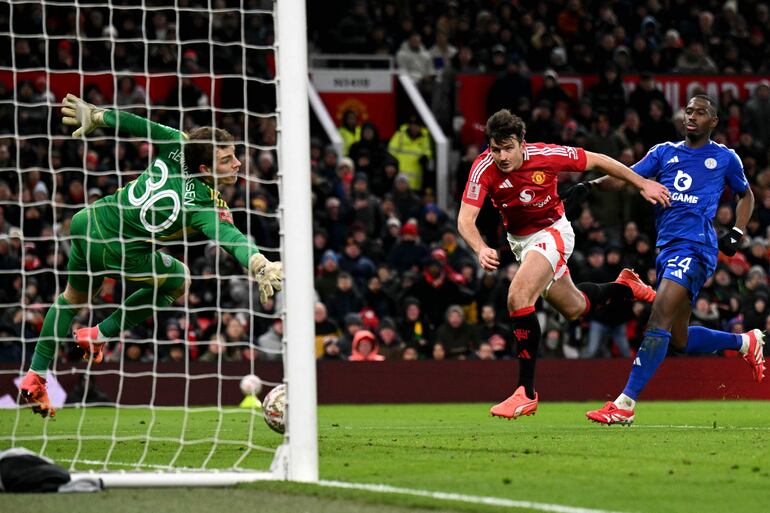 Manchester United's English defender #05 Harry Maguire scores the team's second goal during the English FA Cup fourth round football match between Manchester United and Leicester City at Old Trafford in Manchester, north west England, on February 7, 2025. (Photo by Oli SCARFF / AFP) / RESTRICTED TO EDITORIAL USE. No use with unauthorized audio, video, data, fixture lists, club/league logos or 'live' services. Online in-match use limited to 120 images. An additional 40 images may be used in extra time. No video emulation. Social media in-match use limited to 120 images. An additional 40 images may be used in extra time. No use in betting publications, games or single club/league/player publications. / 