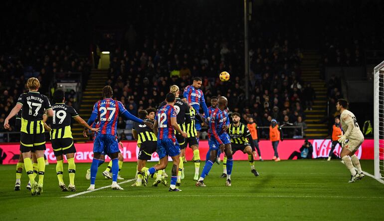 TOPSHOT - Crystal Palace's French defender #05 Maxence Lacroix (C) heads the ball and scores his team second goal during the English Premier League football match between Crystal Palace and Manchester City at Selhurst Park in south London on December 7, 2024. (Photo by Glyn KIRK / AFP) / RESTRICTED TO EDITORIAL USE. No use with unauthorized audio, video, data, fixture lists, club/league logos or 'live' services. Online in-match use limited to 120 images. An additional 40 images may be used in extra time. No video emulation. Social media in-match use limited to 120 images. An additional 40 images may be used in extra time. No use in betting publications, games or single club/league/player publications. / 