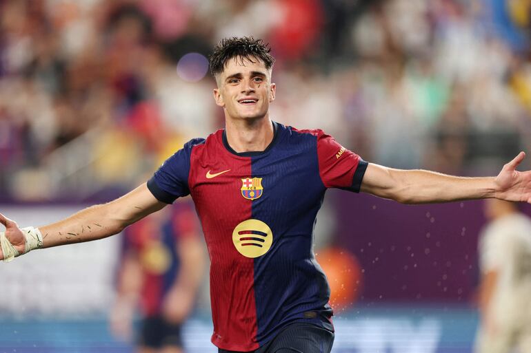 Barcelona's Spanish forward #08 Pau Victor celebrates after scoring a goal during the pre-season club friendly football match between Real Madrid and Barcelona at MetLife Stadium in East Rutherford, New Jersey, August 3, 2024. (Photo by Charly TRIBALLEAU / AFP)