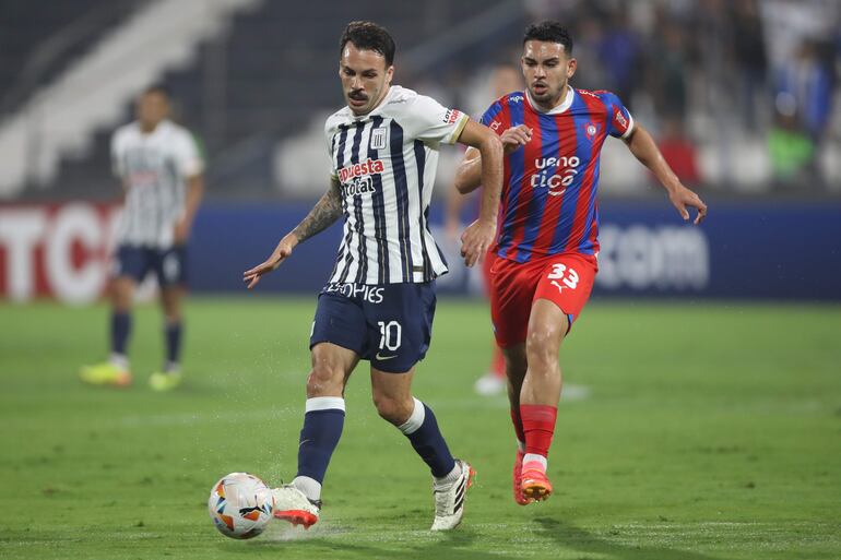 Sebastián Rodríguez (i) de Alianza disputa el balón con Fabrizio Peralta de Cerro Porteño este miércoles, en un partido de la fase de grupos de la Copa Libertadores entre Alianza Lima y Cerro Porteño en el estadio Alejandro Villanueva en Lima (Perú).