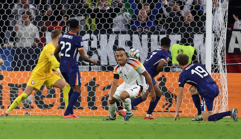 Germany's midfielder #07 Jamie Leweling (C) celebrates after scoring the opening goal during the UEFA Nations League, League A Group A3 football match between Germany and the Netherlands in Munich, southern Germany on October 14, 2024. (Photo by Alexandra BEIER / AFP)