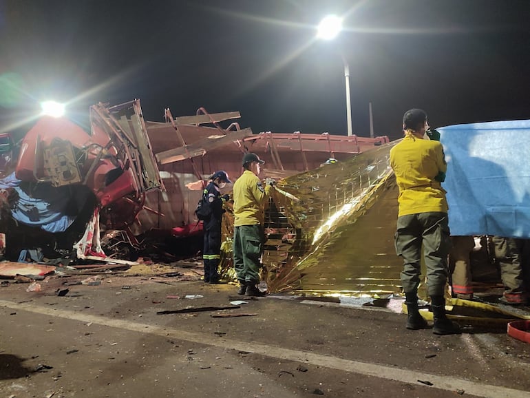 Rescatistas trabajan en el sitio del accidente en Pedrozo, el domingo.