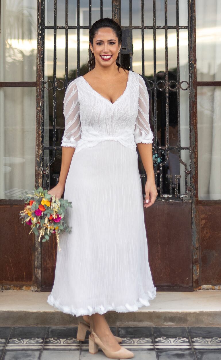 El vestido de la novia fue diseñado y confeccionado por Magalí Rodríguez, el ramo fue preparado con flores coloridas y eucaliptos. 