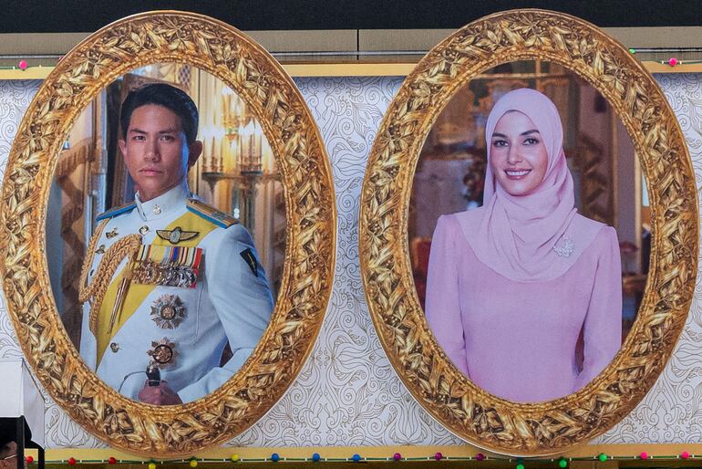 Retratos del príncipe Abdul Mateen y Yang Mulia Anisha Rosnah  en un cartel gigante.