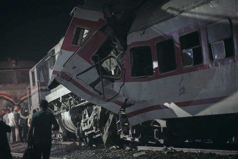 Vecinos y rescatistas se reúnen en el lugar donde chocaron dos trenes, en la ciudad de Zagazig, gobernación de Sharqiya, Egipto