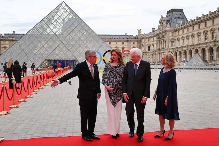 El presidente del Comité Olímpico Internacional (COI), Thomas Bach, y su esposa Claudia Bach, saludan al presidente italiano Sergio Mattarella y a su hija Laura Mattarella a su llegada a Louvre. (Ludovic MARIN / POOL / AFP) 