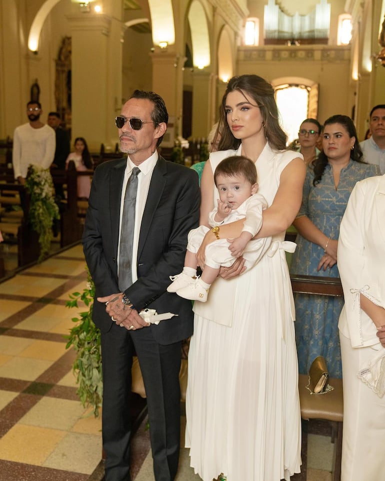 Marc Anthony y Nadia Ferreira, con su nuevo ahijado, atentos a la ceremonia de bautismo. (Instagram/Ludy Ferreira)