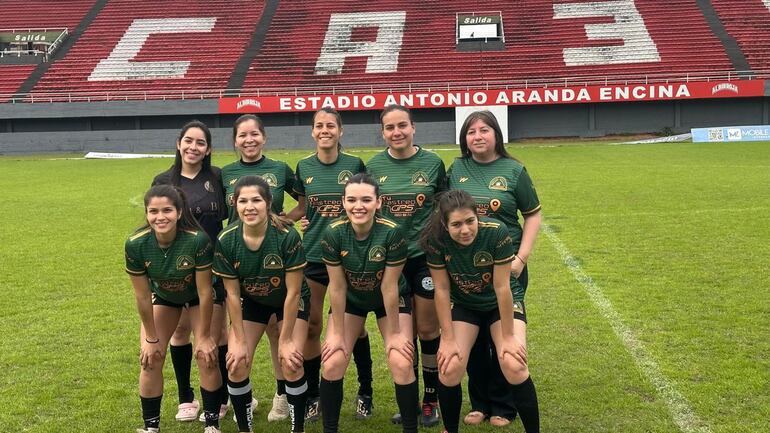 El equipo de fútbol de campo femenino de la Universidad Nacional del Este (UNE) se prepara para un partido.