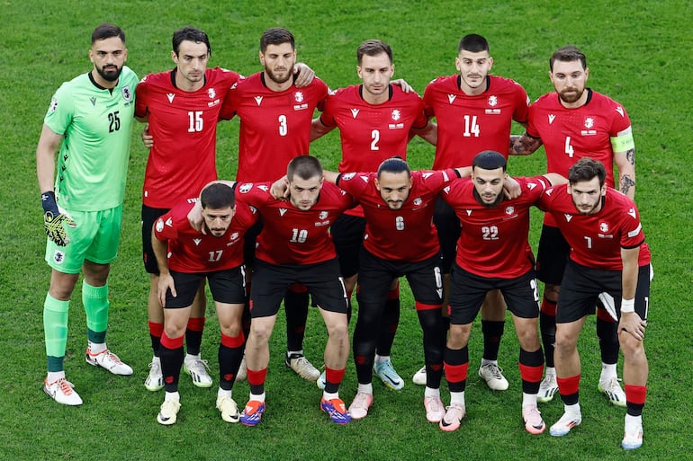 Portugal's players including (From L) Georgia's goalkeeper #25 Giorgi Mamardashvili, Georgia's defender #15 Giorgi Gvelesiani, Georgia's midfielder #17 Otar Kiteishvili, Georgia's defender #03 Lasha Dvali, Georgia's midfielder #10 Giorgi Chakvetadze, Georgia's defender #02 Otar Kakabadze, Georgia's midfielder #06 Giorgi Kochorashvili, Georgia's defender #14 Luka Lochoshvili, Georgia's forward #22 Georges Mikautadze, Georgia's defender #04 Guram Kashia and Georgia's forward #07 Khvicha Kvaratskhelia pose prior to the UEFA Euro 2024 Group F football match between Georgia and Portugal at the Arena AufSchalke in Gelsenkirchen on June 26, 2024. (Photo by KENZO TRIBOUILLARD / AFP)