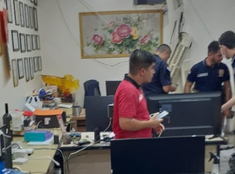 Agentes de la Policía Nacional realizan su trabajo en la oficina administrativa del local asaltado.