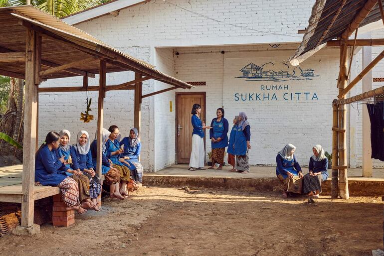 Denica Riadini-Flesch conversa con mujeres en una de las escuelas de oficios de SukkhaCitta. © Rolex/Sébastien Agnetti.
