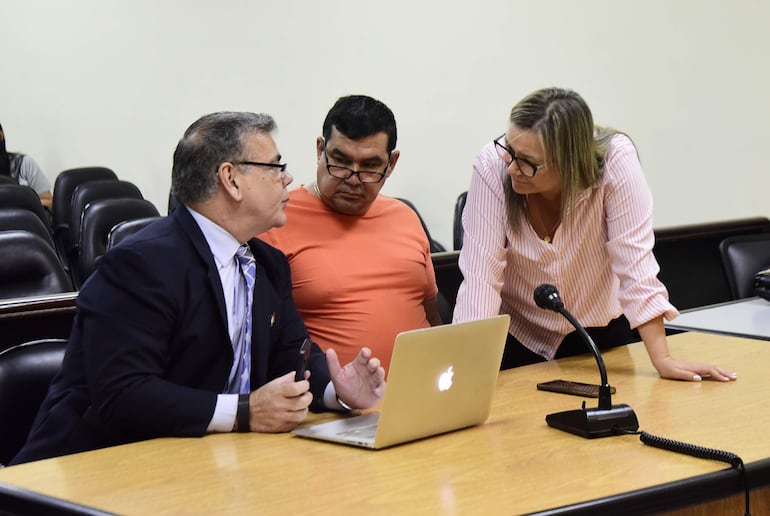 Osvaldo Vera Espínola (remera naranja) conversa con sus abogados.