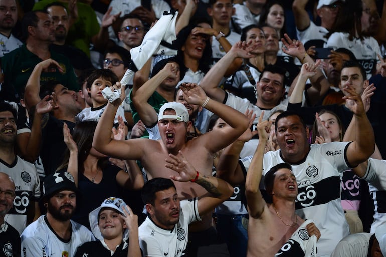 Los hinchas de Olimpia celebran en un partido de los octavos de final de la Copa Libertadores ante Flamengo en el estadio Defensores del Chaco en Asunción, Paraguay.