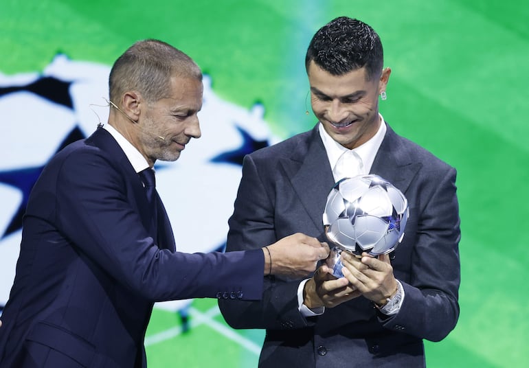 El futbolista portugués Cristiano Ronaldo recibe un Premio Especial del Presidente de la UEFA, Aleksander Ceferin, por ser el máximo goleador de la Liga de Campeones con 140 goles. (EFE/EPA/SEBASTIEN NOGIER)
