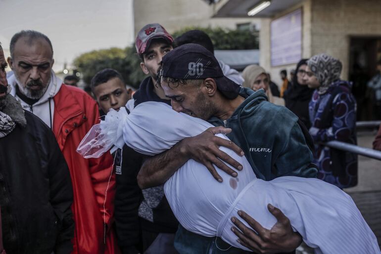 Un hombre con el cadáver de su hija en brazos el lunes en el hospital Mártires de Al Aqsa, en Deir el Balah, en la zona central de la Franja de Gaza.