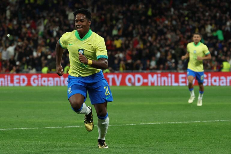 Brazil's forward #21 Endrick celebrates scoring his team's second goal during the international friendly football match between Spain and Brazil at the Santiago Bernabeu stadium in Madrid, on March 26, 2024. Spain arranged a friendly against Brazil at the Santiago Bernabeu under the slogan "One Skin" to help combat racism. (Photo by Pierre-Philippe MARCOU / AFP)