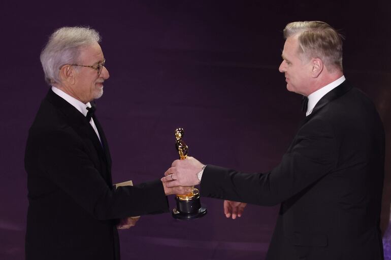 El cineasta Steven Spielberg (a la izquierda) entrega a Christopher Nolan el Óscar a la mejor dirección por "Oppenheimer".