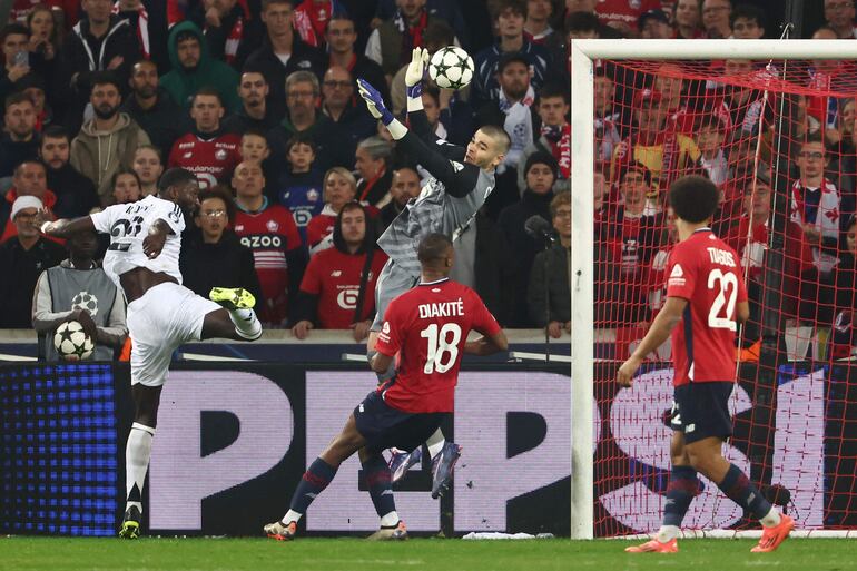 Lille's French goalkeeper #30 Lucas Chevalier stops a header by Real Madrid's German defender #22 Antonio Ruediger (L) during the UEFA Champions League football match between Lille LOSC and Real Madrid at the Pierre Mauroy Stadium in Villeneuve-d'Ascq, northern France, on October 2, 2024. (Photo by Sameer Al-Doumy / AFP)