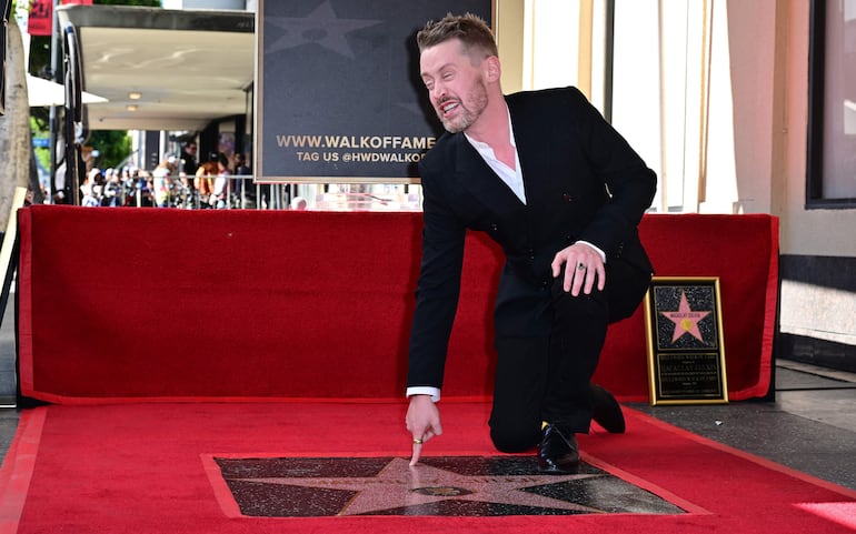 El actor estadounidense Macaulay Culkin hace un gesto cerca de su recién inaugurada estrella del Paseo de la Fama de Hollywood en Hollywood, California, el 1 de diciembre de 2023.