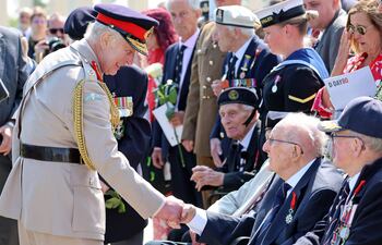 El rey británico Carlos III saluda a los veteranos y sus familiares durante la recordación de los 80 años del "Desembarco de Normandía".