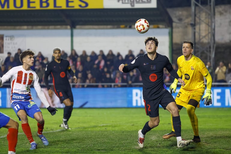 BARBASTRO (HUESCA), 04/01/2025.-El defensa del Barcelona Pau Cubarsí y el centrocampista del Barbastro Marc Prat (i), durante el partido de dieciseisavos de la Copa del Rey, este sábado en el Campo Municipal de Deportes de Barbastro.-EFE/ Javier Cebollada
