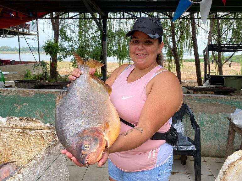 Fátima Oviedo, vendedora local, con un ejemplar de pacú, que es una delicia a la parrilla.