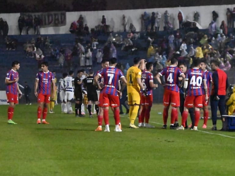 Los jugadores de Cerro Porteño beben agua durante el apagón en el estadio Río Parapití, en Pedro Juan Caballero.