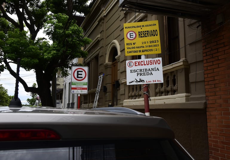 Se pueden ver varios carteles de estacionamiento reservado con el año "2023".