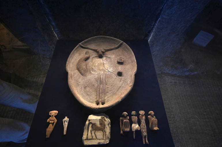 Los visitantes observan artefactos recién desenterrados durante un evento para los medios en el que se anunciaron nuevos descubrimientos de una misión arqueológica egipcia en el Templo del Valle de la Reina Hatshepsut, en Deir El-Bahari, en la ribera occidental del Nilo, en Luxor.