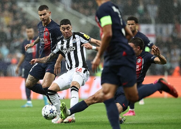 El paraguayo Miguel Almirón, jugador del Newcastle, pelean por el balón con los jugadores del París Saint-Germain en un partido de la segunda fecha de la fase de grupos de la Champions League.