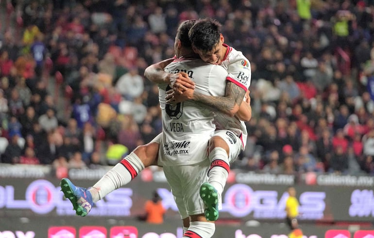 Toluca's forward #09 Ernesto Vega celebrates with teammate Paraguayan forward #31 Robert Morales after scoring a goal against Tijuana during the Liga MX Clausura football league match between Tijuana and Toluca at Caliente stadium in Tijuana, Baja California, Mexico on January 10, 2025. (Photo by Guillermo Arias / AFP)