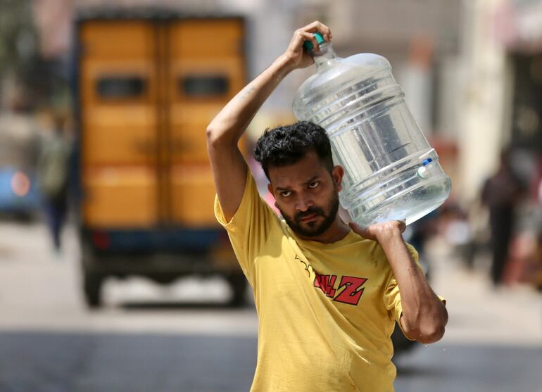 Un hombre transporta un botellón de agua. El Colegio de Químicos de Puerto Rico (CQPR) informó este lunes que una investigación reveló que el agua potable en dos áreas del sur de la isla contiene metales pesados, tóxicos y cancerígenos por el depósito de cenizas de carbón en el acuífero de esta zona.