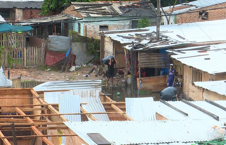 Habitantes de la Chacarita construyen precarias viviendas con materiales de madera y zinc como lugar de refugio temporal mientras dure la crecida del río Paraguay en la costa de Asunción.