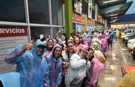 Fans de Karol G refugiándose de la lluvia