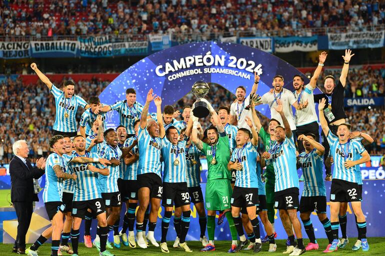 Racing's players celebrate with the trophy after winning the Copa Sudamericana final football match between Argentina's Racing and Brazil's Cruzeiro at La Nueva Olla Stadium in Asuncion on November 23, 2024. (Photo by Daniel Duarte / AFP)