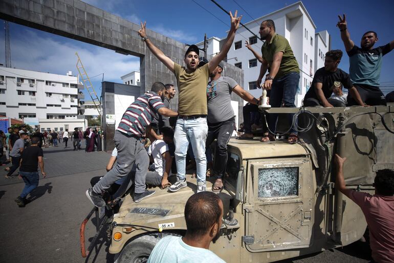 Palestinos conducen un jeep militar israelí por las calles de Gaza.