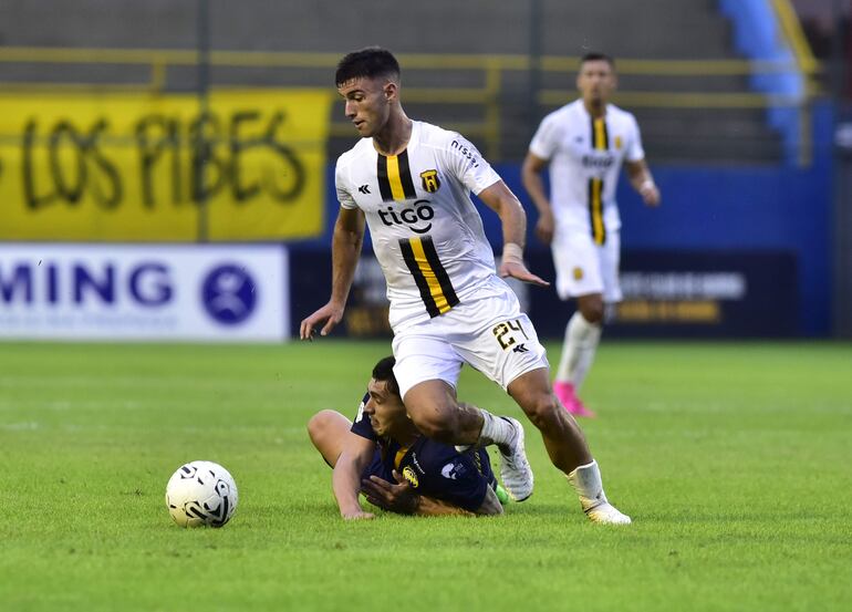 Felipe Salomoni gana en fuerza y potencia ante el jugador de Trinidense y se lleva el balón.