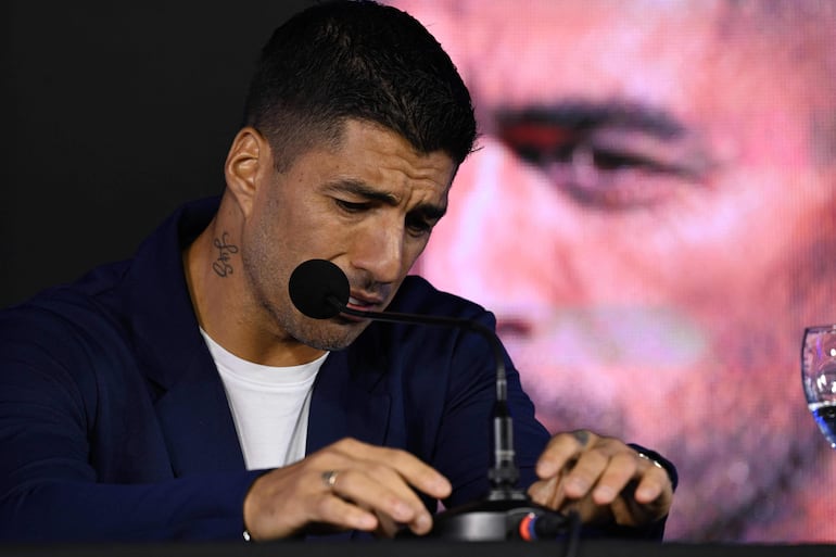 Uruguay's forward Luis Suarez gets emotional during a press conference at the Centenario Stadium in Montevideo on September 2, 2024. Luis Suarez, Uruguay's all-time leading scorer, announced that he will play his last game for La Celeste this Friday against Paraguay in Montevideo, on the seventh round of the South American qualifiers for the World Cup North America-2026. (Photo by Eitan ABRAMOVICH / AFP)