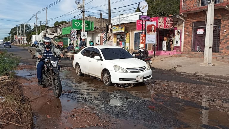 Los motociclistas se bañan de agua, y los automovilistas caen en los baches de la Avda. Luis María Argaña y Pirizal.