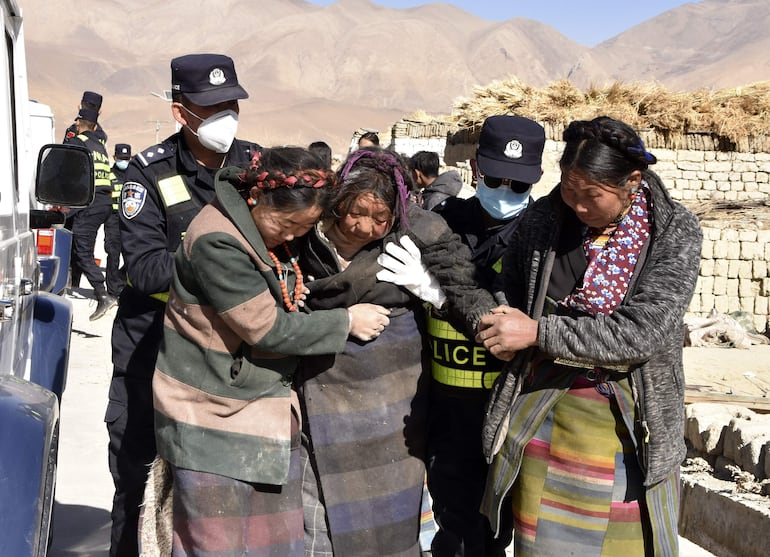 Rescatistas ayudan a personas afectadas por el seísmo, el martes en la localidad de Zhacun.