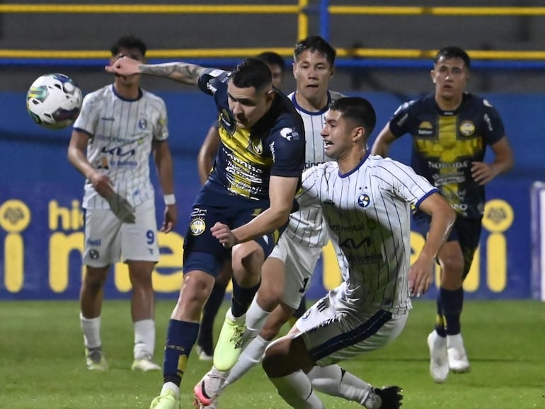 Diego Torres (i), jugador del Sportivo Trinidense, pelea por el balón en el partido frente a Sol de América por la novena fecha del torneo Clausura 2024 del fútbol paraguayo en el estadio Martín Torres, en Asunción.