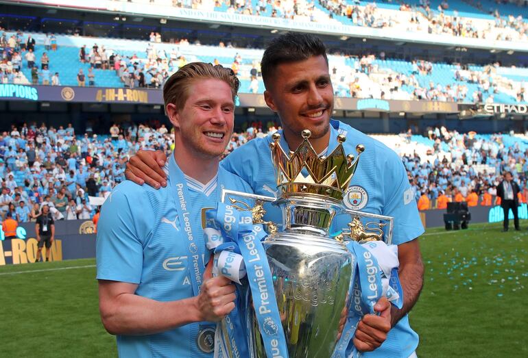 Manchester (United Kingdom), 19/05/2024.- Manchester City's Kevin De Bruyne (L) and Rodri pose with the Premier League championship trophy, the fourth consecutive won by City, after the English Premier League soccer match of Manchester City against West Ham United, in Manchester, Britain, 19 May 2024. (Liga de Campeones, Reino Unido) EFE/EPA/ASH ALLEN EDITORIAL USE ONLY. No use with unauthorized audio, video, data, fixture lists, club/league logos, 'live' services or NFTs. Online in-match use limited to 120 images, no video emulation. No use in betting, games or single club/league/player publications.
