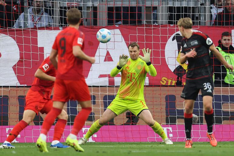 Bayern Munich's German goalkeeper #01 Manuel Neuer makes a save during the German first division Bundesliga football match FC Bayern Munich vs 1 FC Union Berlin in Munich, southern Germany, on November 2, 2024. (Photo by Alexandra BEIER / AFP) / DFL REGULATIONS PROHIBIT ANY USE OF PHOTOGRAPHS AS IMAGE SEQUENCES AND/OR QUASI-VIDEO