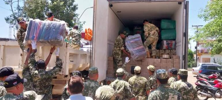 Militares bajan las mercaderías enviadas por la Itaipú BInacional para los afectados por el temporal.