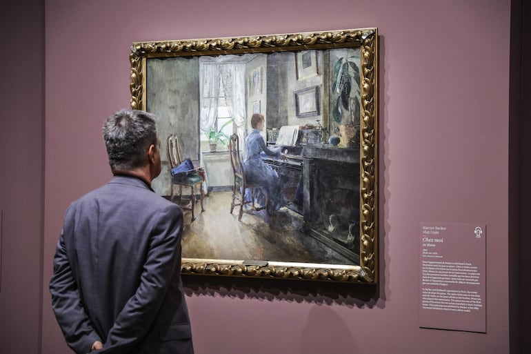 Un hombre mira la pintura 'en casa' de Harriet Backer durante la gira de prensa de la exposición 'Harriet Backer. La música de los colores' en el Museo de Orsay en París.